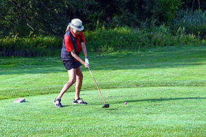 A golfer playing golf in the field