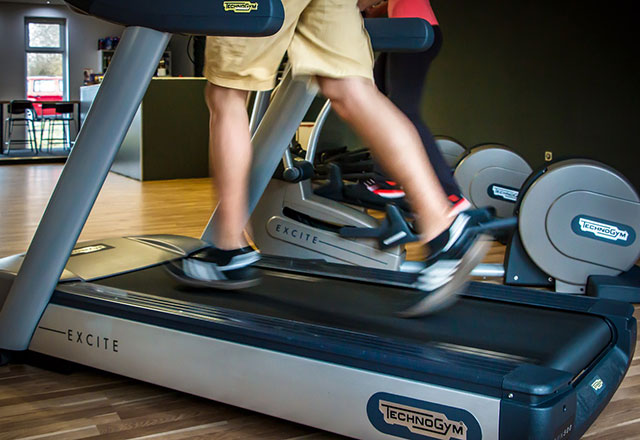 Man running in the treadmill at home